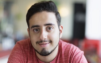 Portrait eines jungen lächelnden Mannes mit rotem T-Shirt