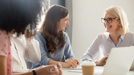Eine Dozentin im Gespräch mit den Teilnehmenden eines Bildungsseminars